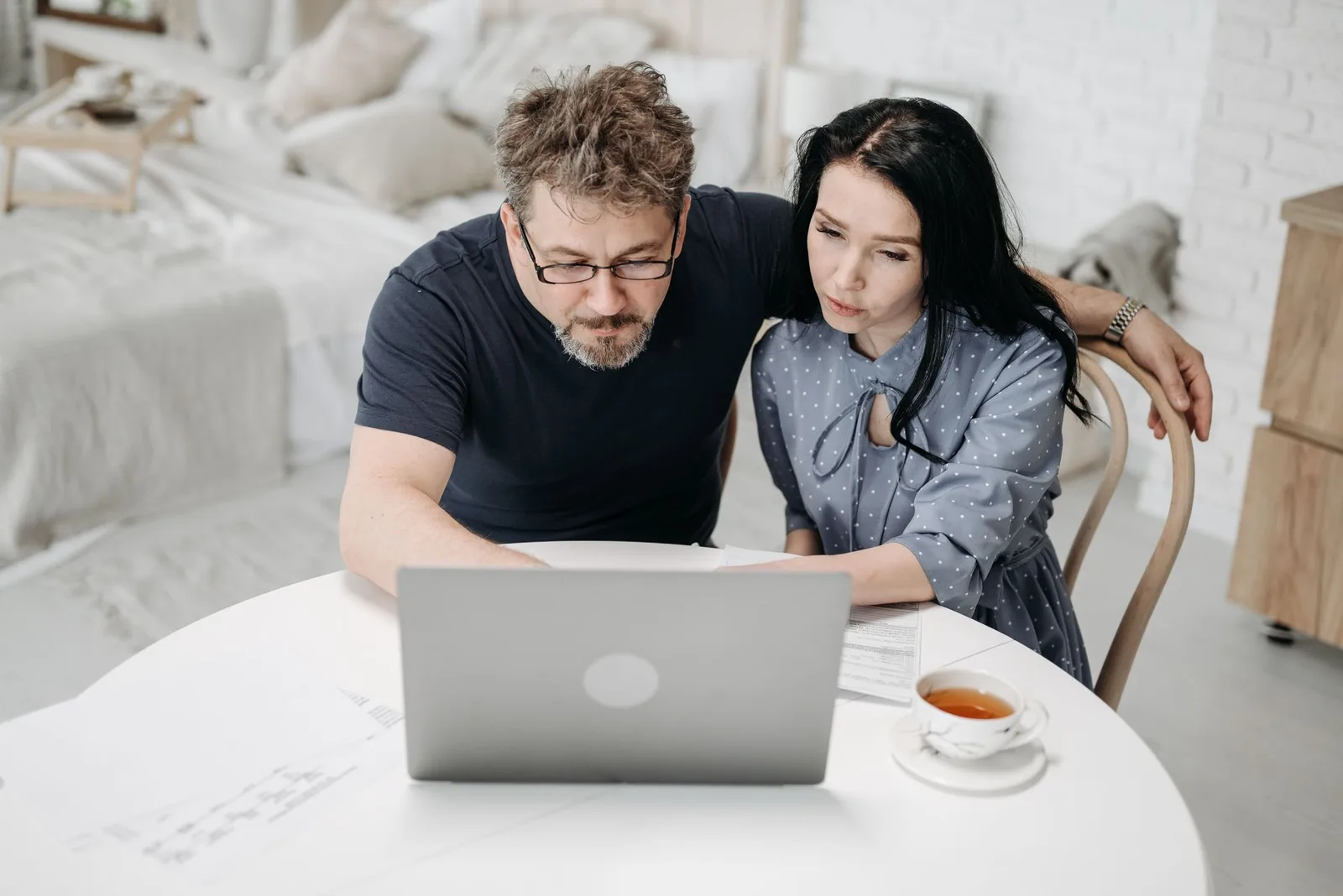 Couple reviewing plans together on a laptop at home