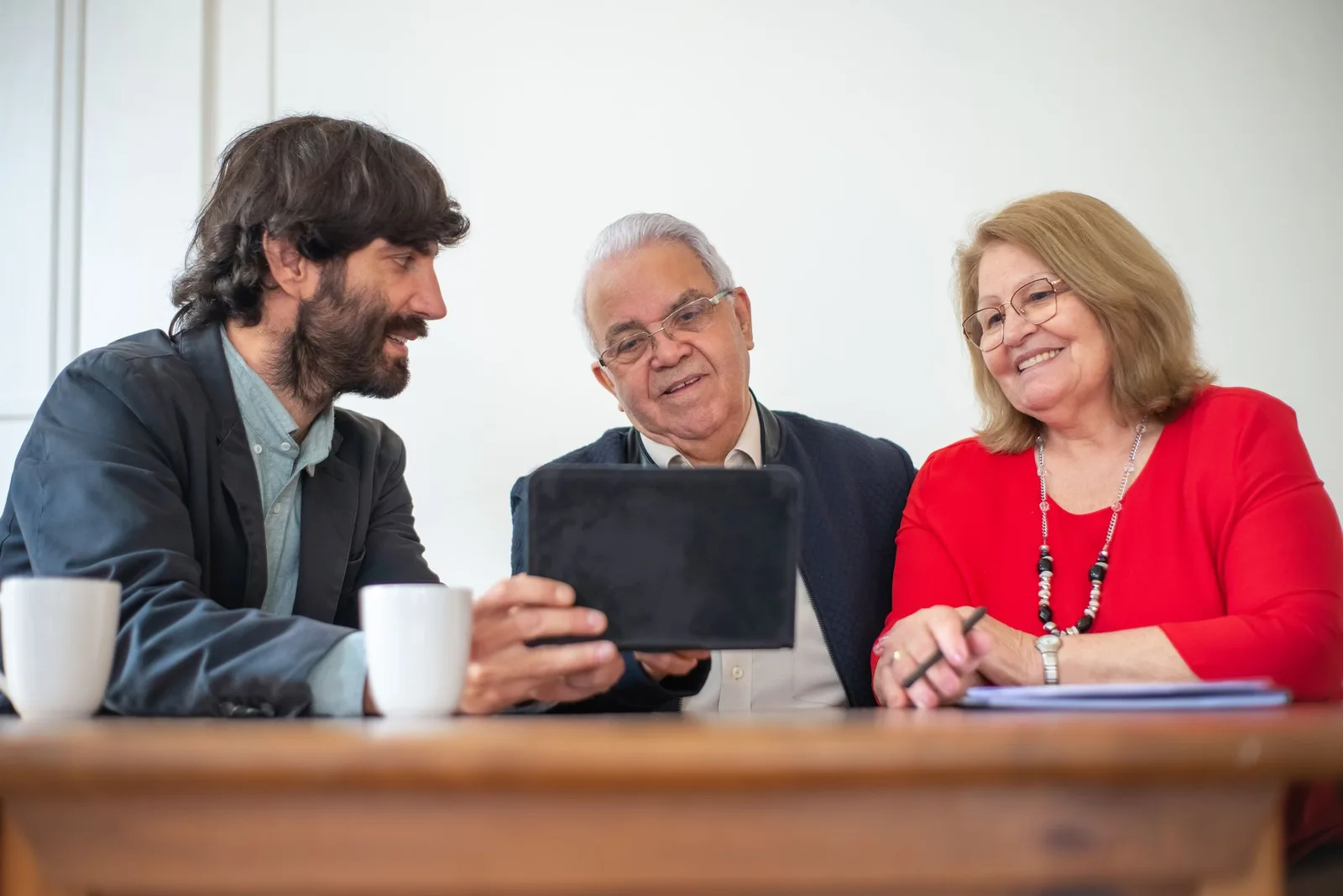 A mature client reviewing financial documents with an adviser